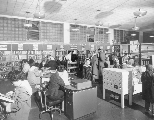 Interior view of Concession Branch of the Hamilton Public Library System, once called the Mountain Branch, which opened in 1930 at 565 Concession Street. Always a popular place for children to gather, here local kids look for library books to enjoy at home. Credit: Local History & Archives, Hamilton Public Library.